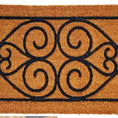 Decorative doormat with black scroll pattern on a brown background