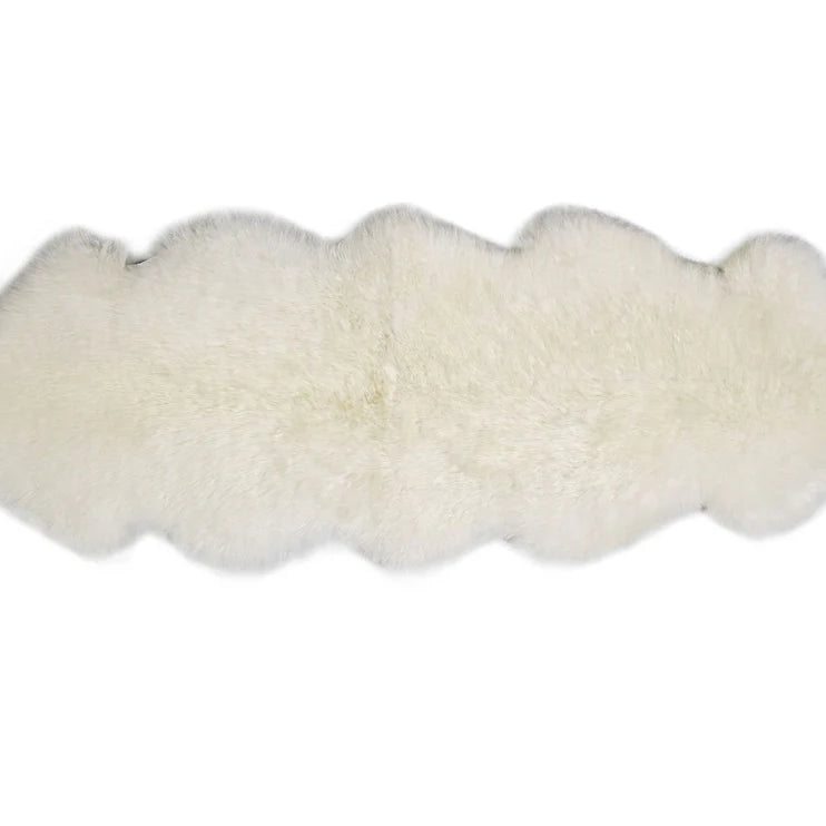 White double sheepskin rug on a white background
