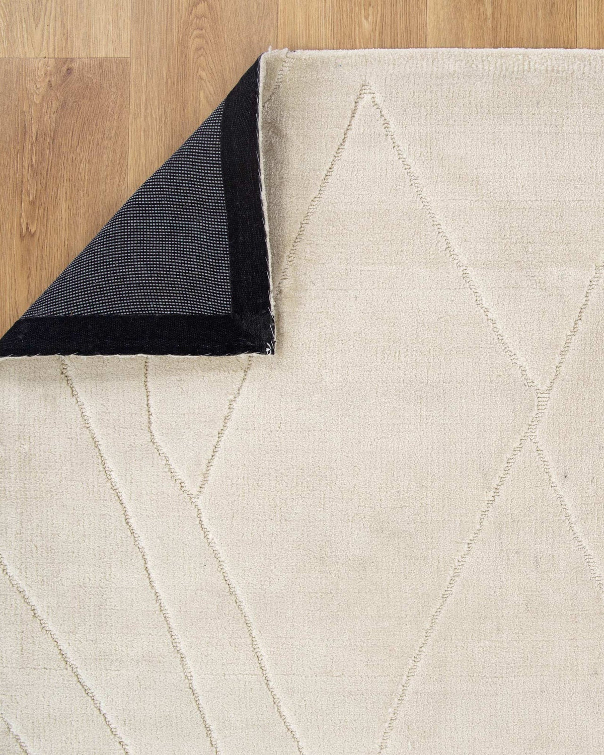 Beige geometric-patterned rug on a wooden floor