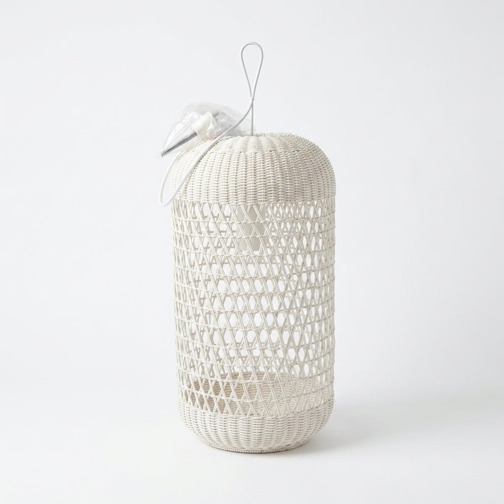 A cylindrical woven rattan hanging lantern in a light natural beige color, featuring a diamond-patterned weave, a top loop for hanging, and a decorative white ribbon bow with a pearl accent on a clean white background.