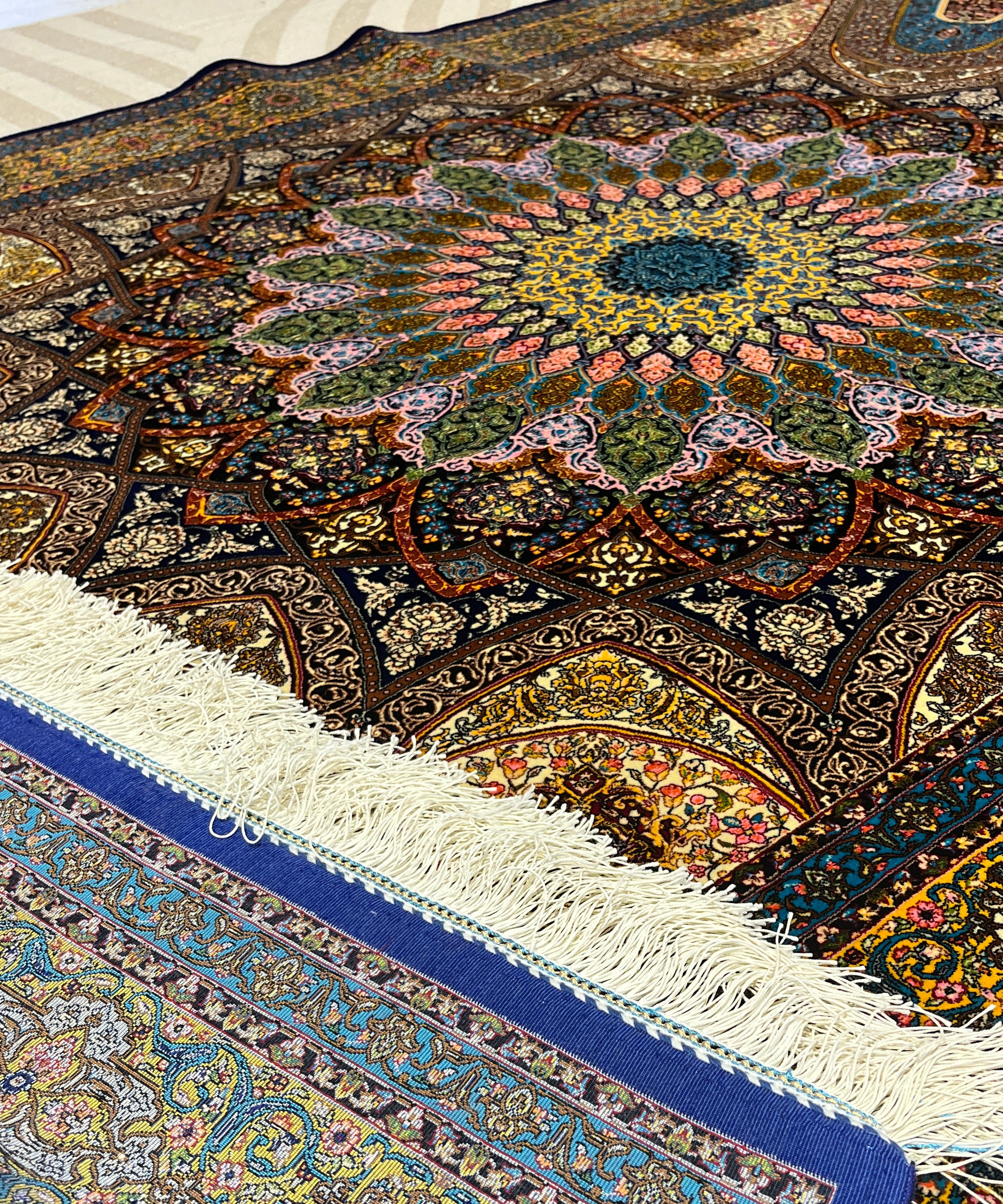 Close-up of intricately patterned rugs with vibrant colors.