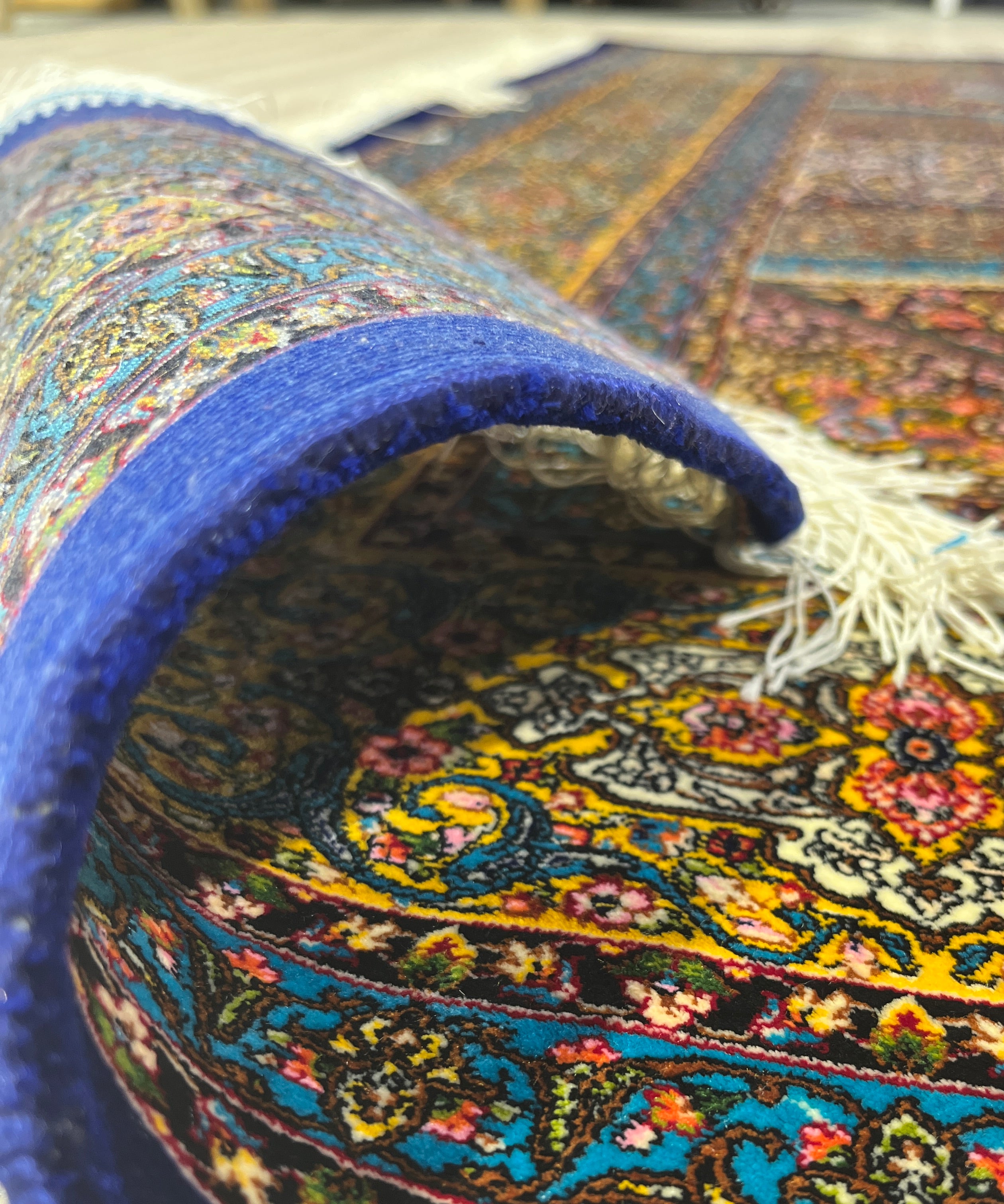 Close-up of a colorful patterned rug with a blue border