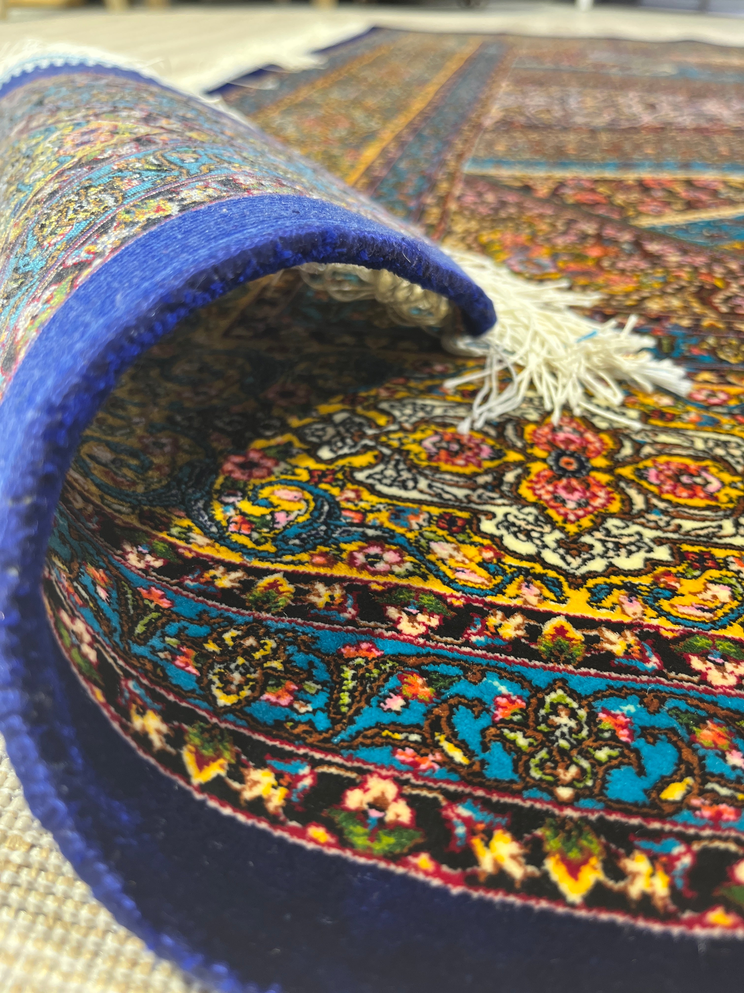 Close-up of a colorful patterned rug with a blue border
