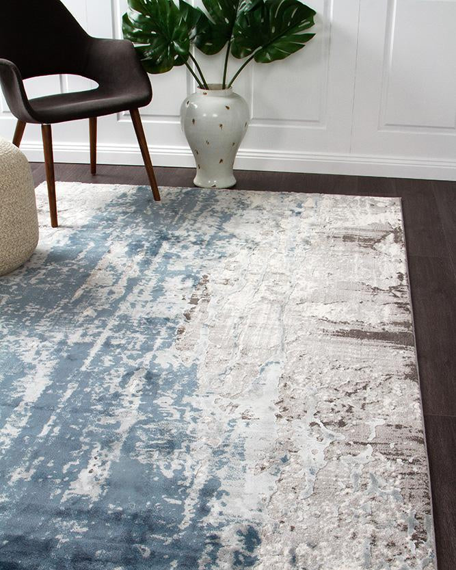 The Kendra Rug in Blue, displayed in a modern room setting, demonstrating its ability to add vibrant colour and style to any space.