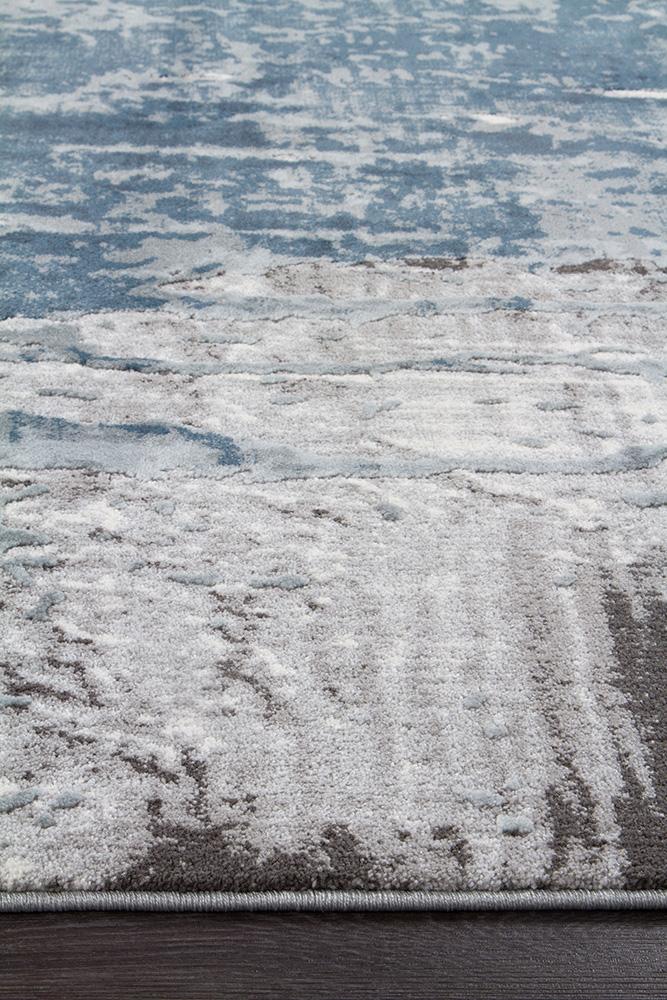 Focused image capturing the precise edging of the Kendra Rug in Blue, showcasing the rug's craftsmanship and quality construction.