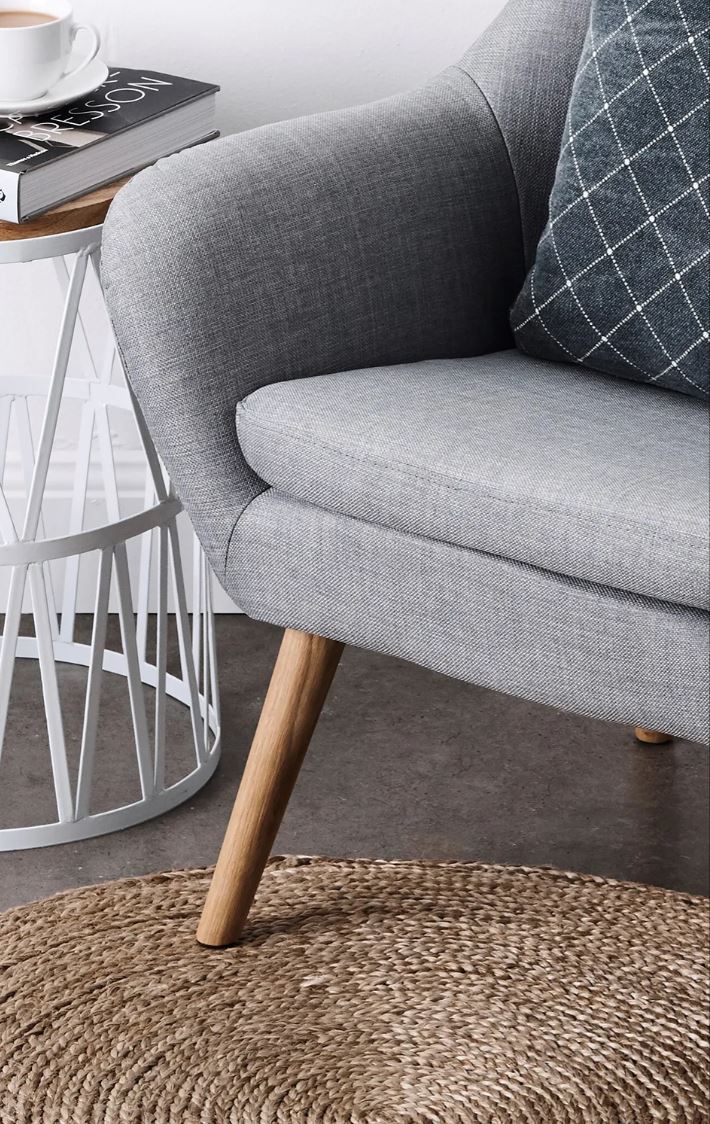 Gray sofa with wooden legs in a living room setting