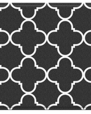 Black and white geometric patterned rug with clover-like shapes