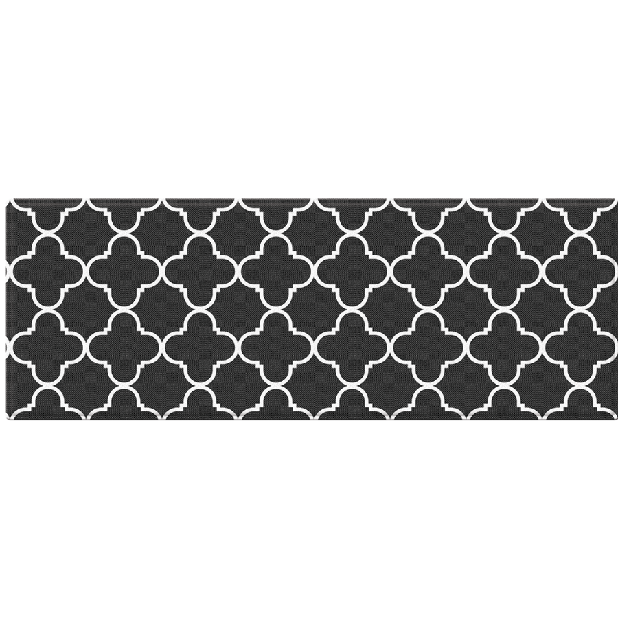 A rectangular black rug with a white geometric quatrefoil trellis pattern, shown against a plain white background.