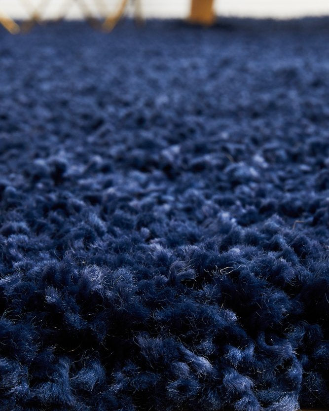 The Laguna Rug in Denim displayed in a modern living space, illustrating its ability to add depth and style to contemporary decor.