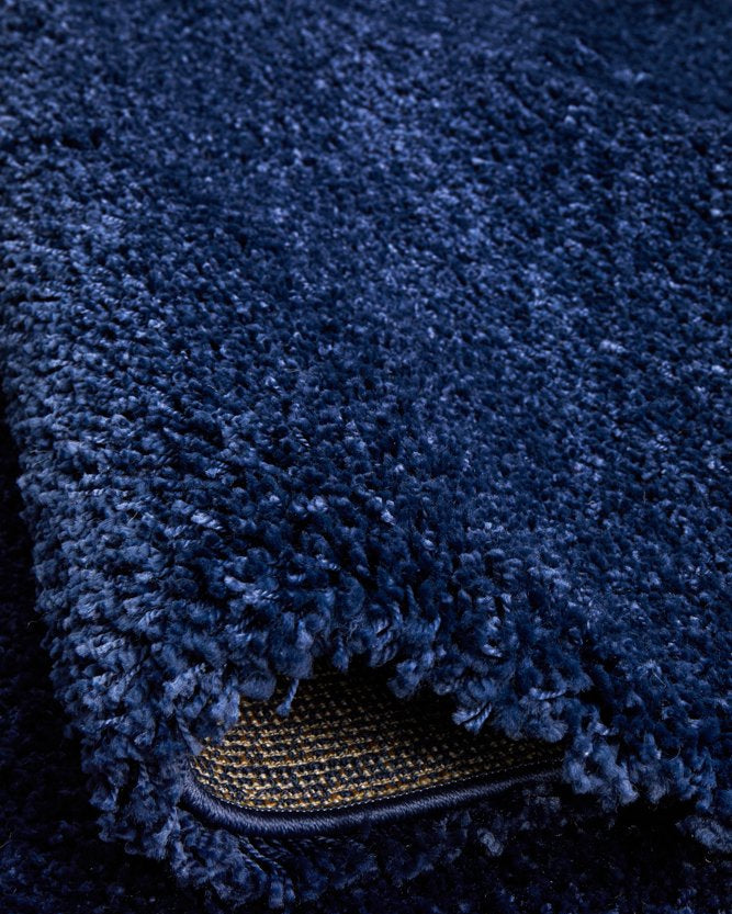 The Laguna Rug in Denim under natural lighting, accentuating the vibrant and warm tones of its denim colour.