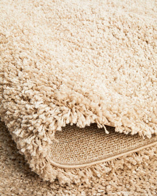 The Laguna Rug in Linen under natural light, emphasising the subtle and natural beauty of its linen hue.