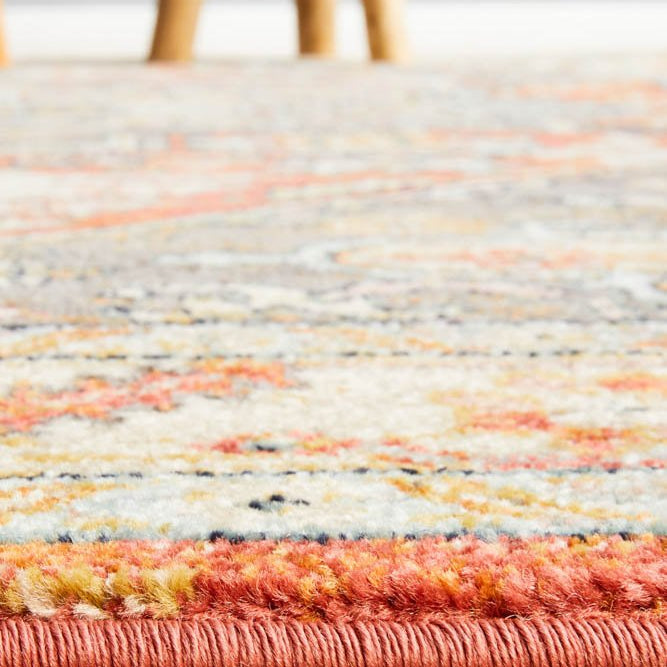 The Legacy Rug in Terracotta elegantly placed in a room setting, showcasing its ability to complement both contemporary and traditional styles.