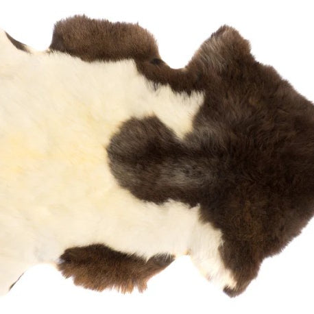 Brown and white fur rug on a white background
