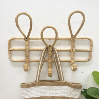 Wicker wall hook with a woven basket on a white background