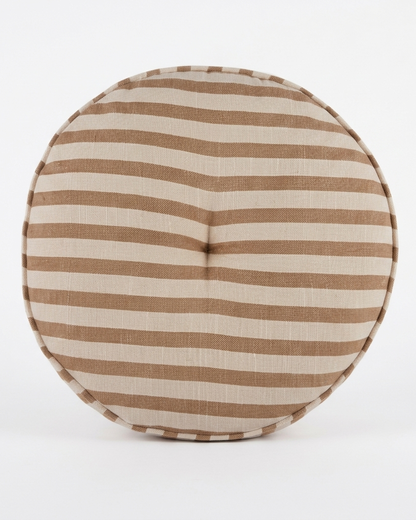 A round floor pouf cushion with horizontal brown and beige stripes, featuring a buttoned center and a stitched edge, shown on a plain white background.