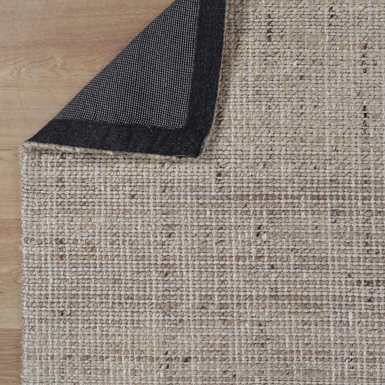 Image of the Dune Jute & Wool Rug folded to display both the top and bottom sides, showcasing the consistent quality and finish across its entire design.