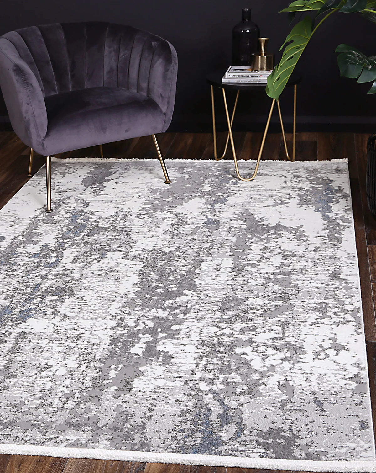 Bohemian Paradise grey-blue rug styled in a modern living room setup with a velvet chair and gold accent table.