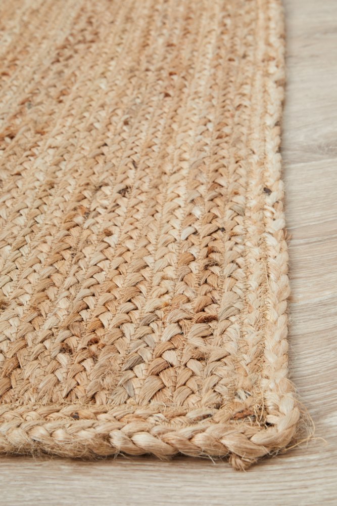 Close-up of a woven jute rug on a wooden floor