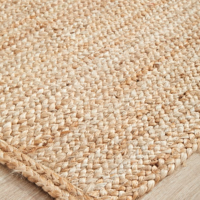 Close-up of a woven jute rug on a wooden floor