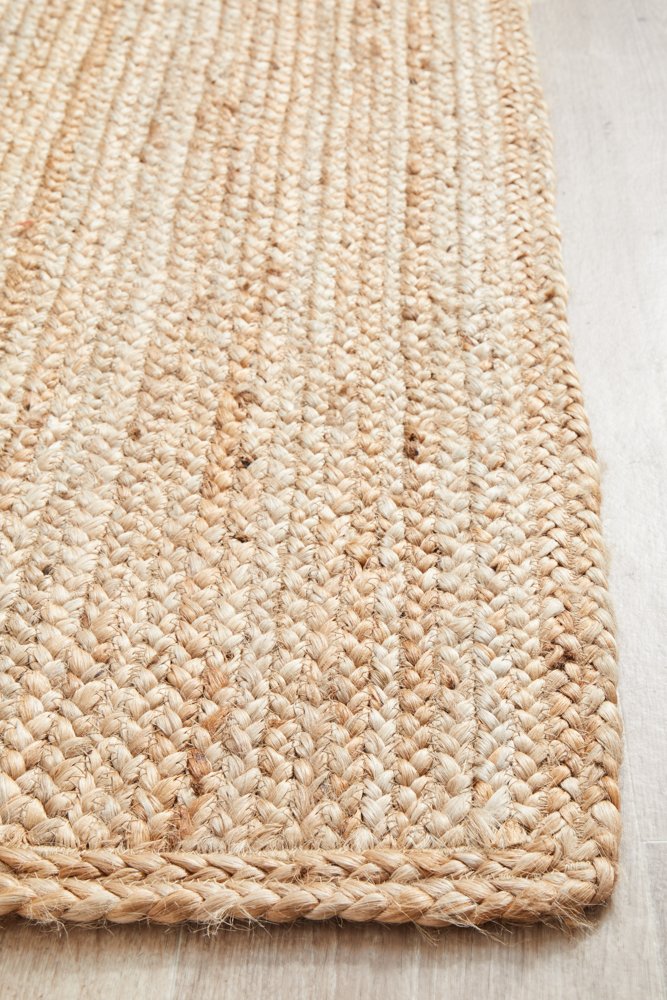 Close-up of a woven jute rug on a wooden floor