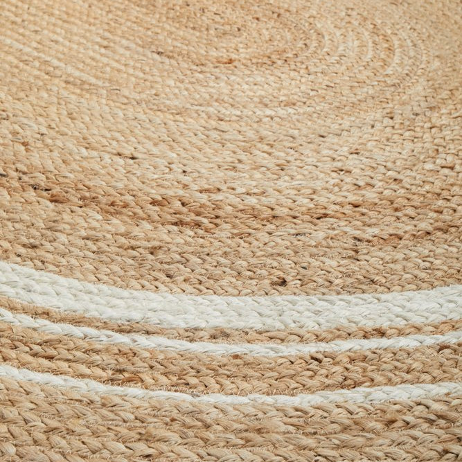 Close-up of a woven jute rug with natural brown and beige colors.
