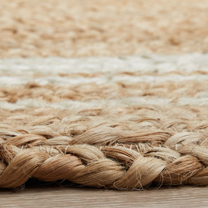 Close-up of a woven jute rug with a natural color palette.