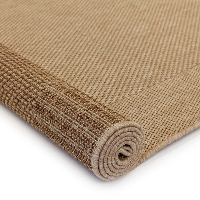 Rolled-up brown woven mat on a white background