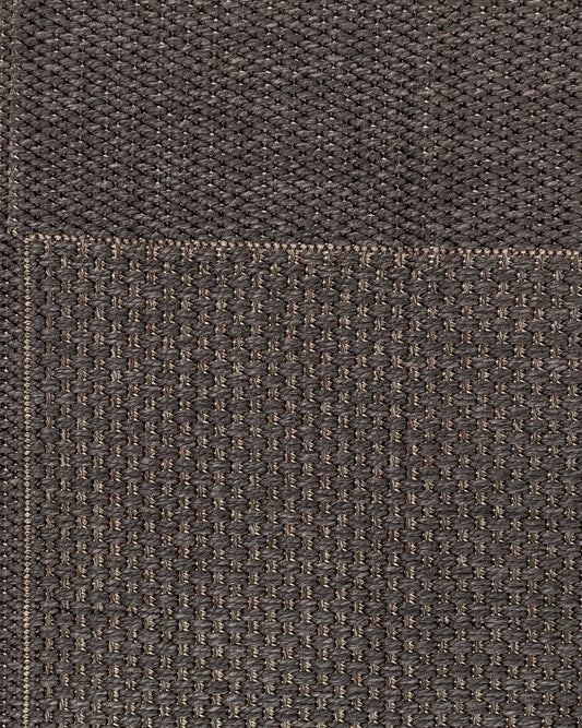 Close-up of brown textured fabric with a visible seam.