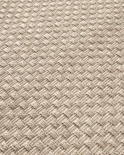 Close-up of a textured beige fabric with a woven pattern