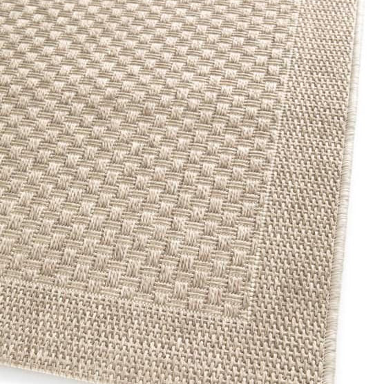 Close-up of a textured beige fabric corner on a white background