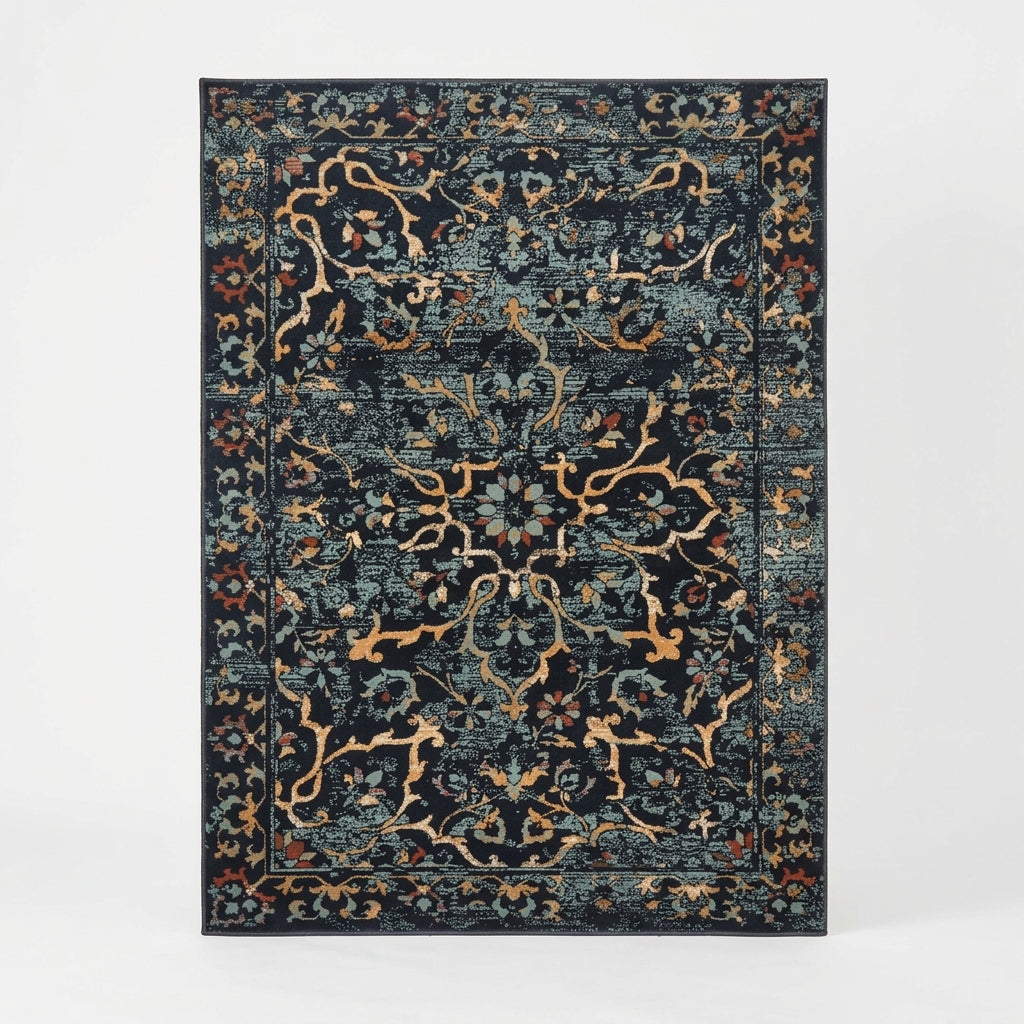 A rectangular area rug with a distressed traditional floral pattern in dark navy blue, teal, and beige, shown flat against a light gray background.