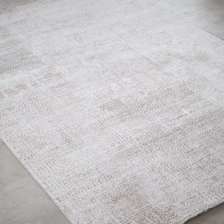 White textured rug on a concrete floor