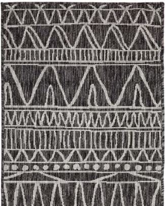 Patterned rug with geometric design on a black background