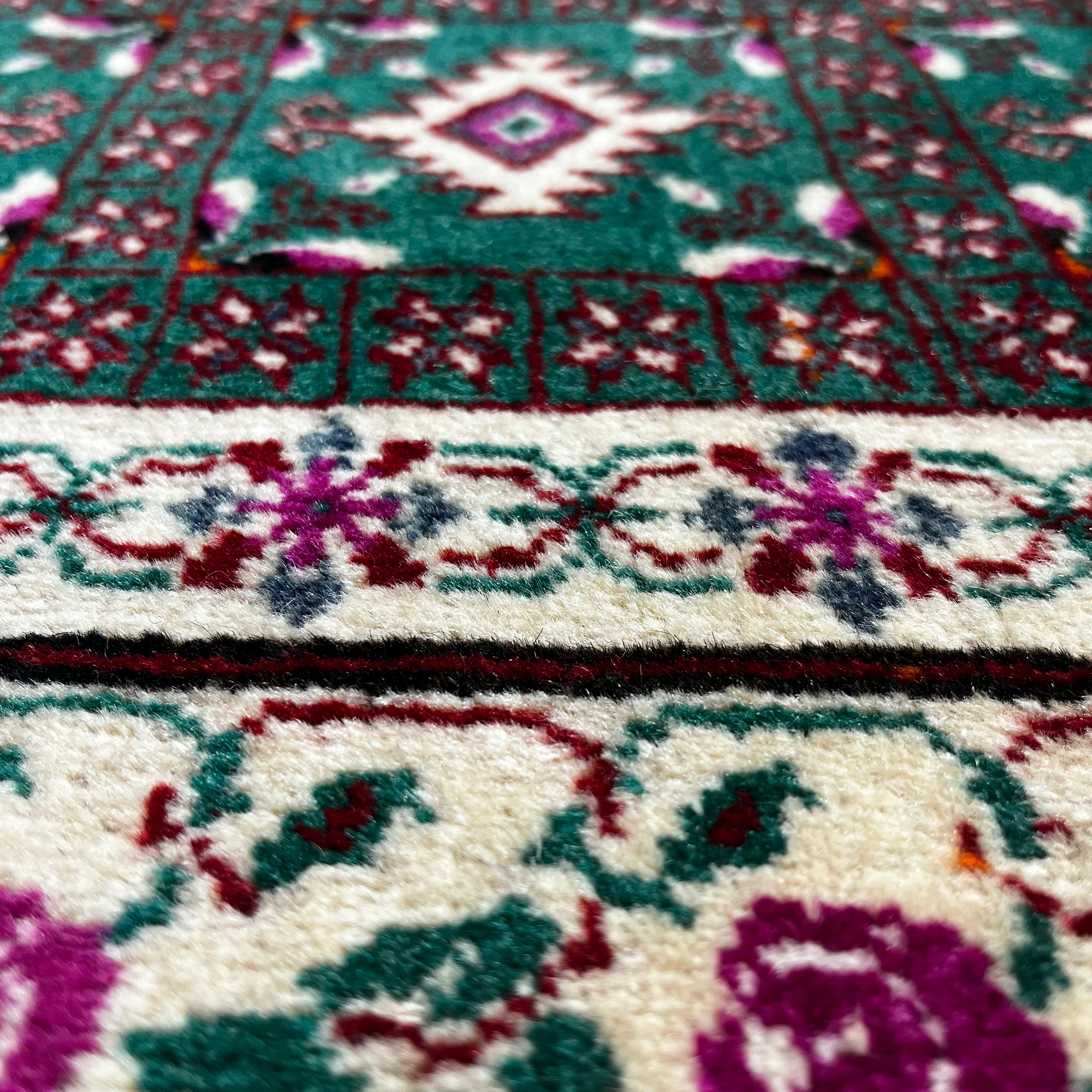Close-up of a patterned rug with floral designs.