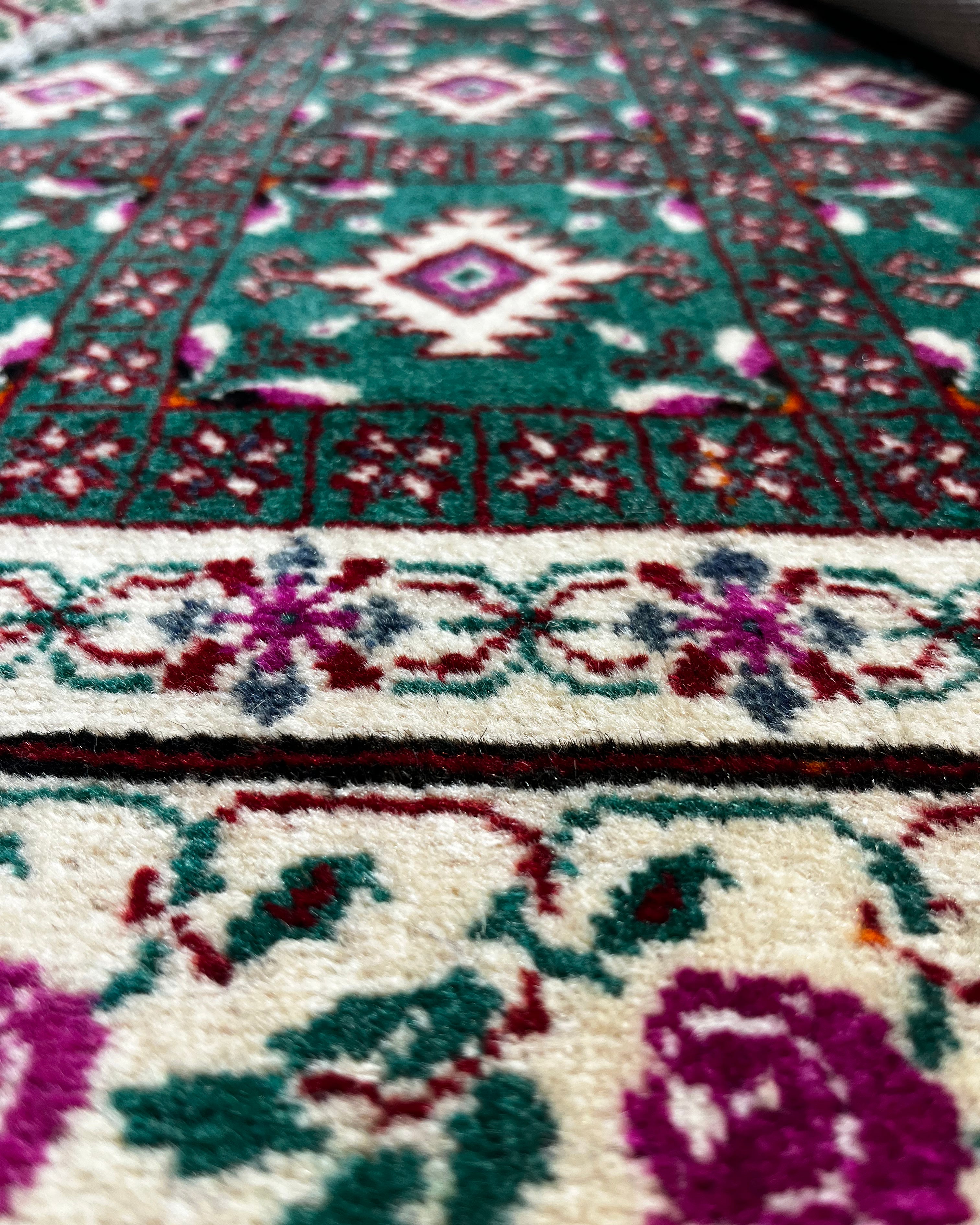 Close-up of a patterned rug with floral designs.