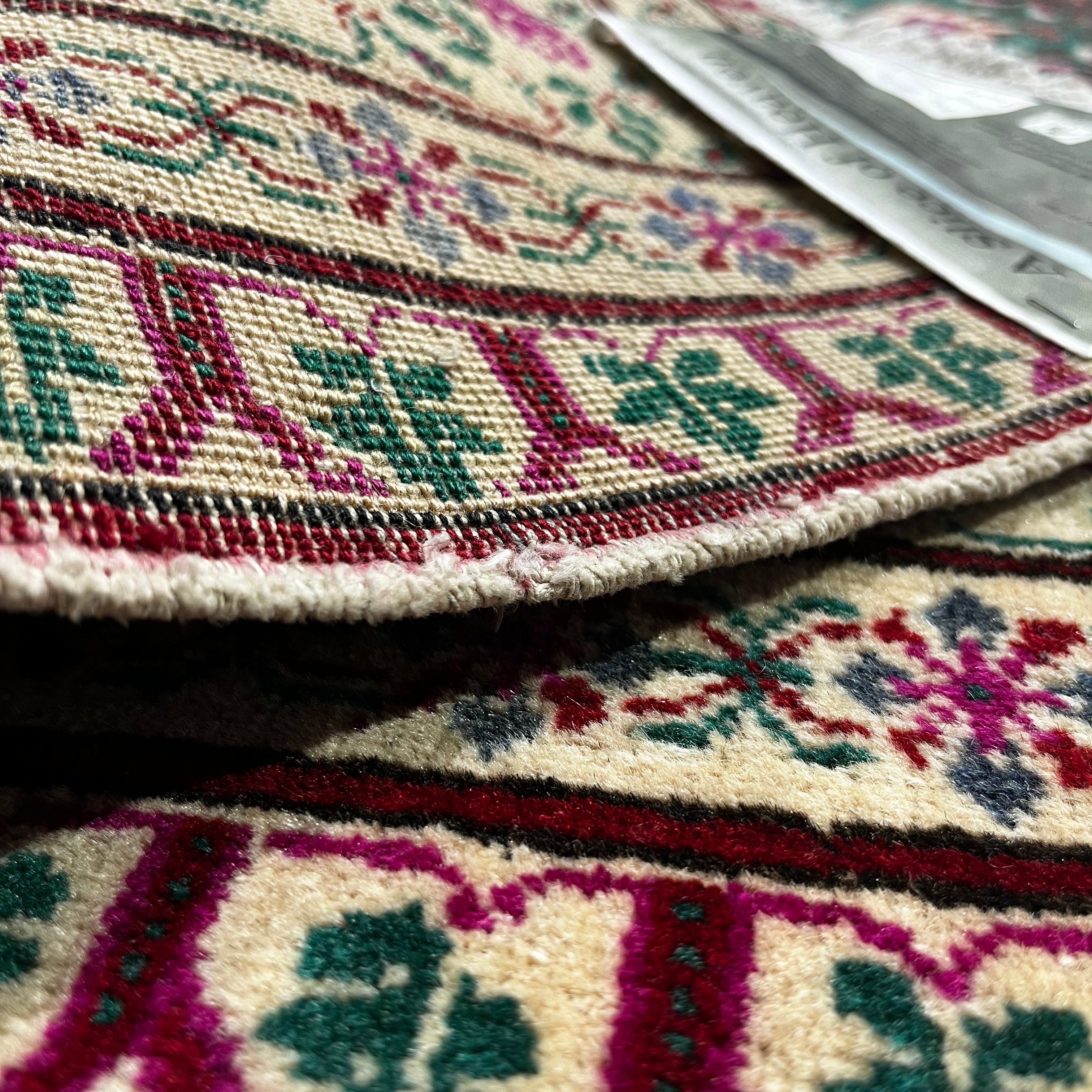 Close-up of a patterned rug with intricate designs.