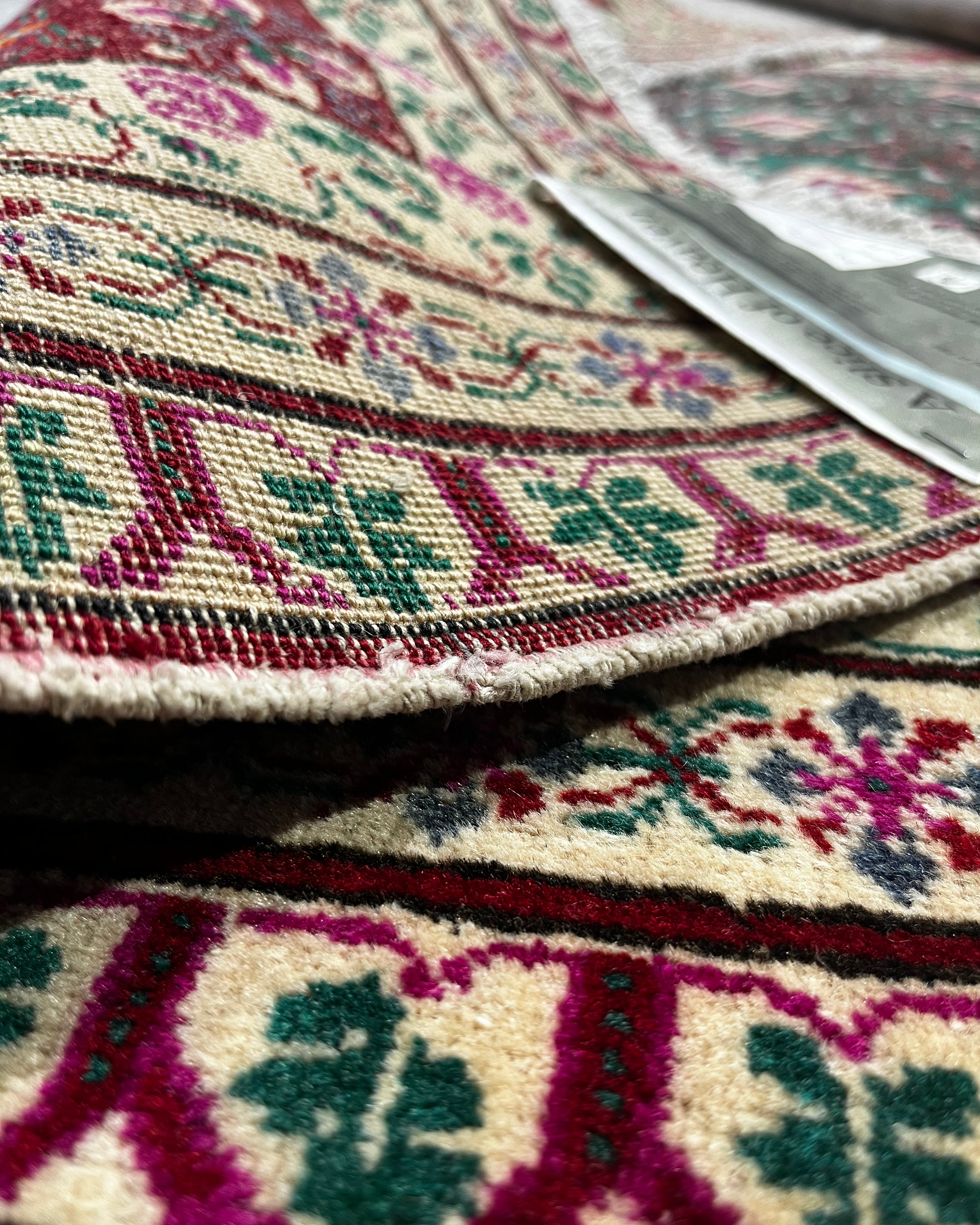 Close-up of a patterned rug with intricate designs.