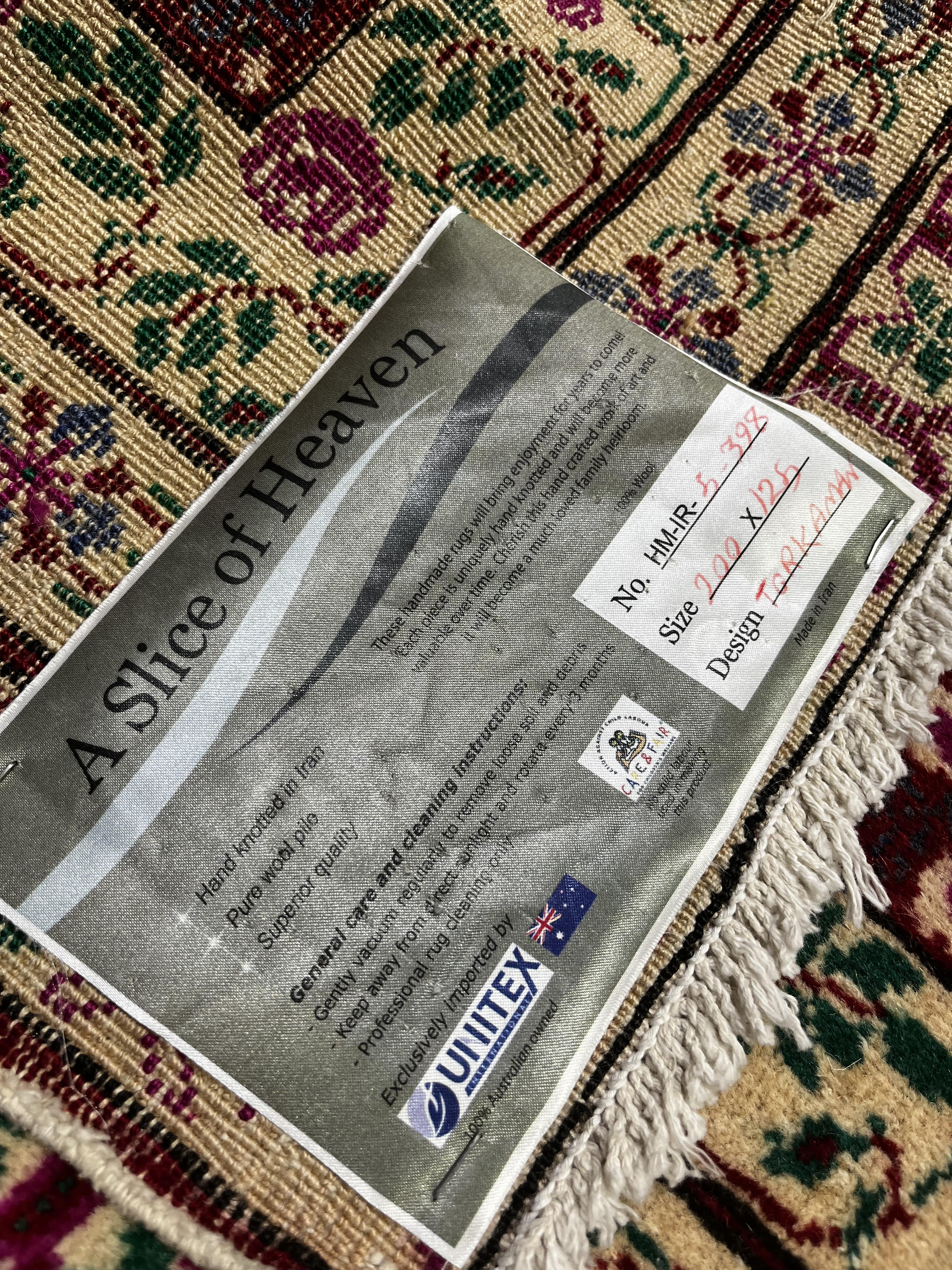 Rug with a 'Slice of Heaven' label on a patterned rug background