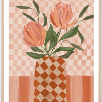 A framed art print featuring a stylized illustration of two peach-orange tulips with green leaves in a checkered terracotta and cream vase, set against a pink and peach checkered background.