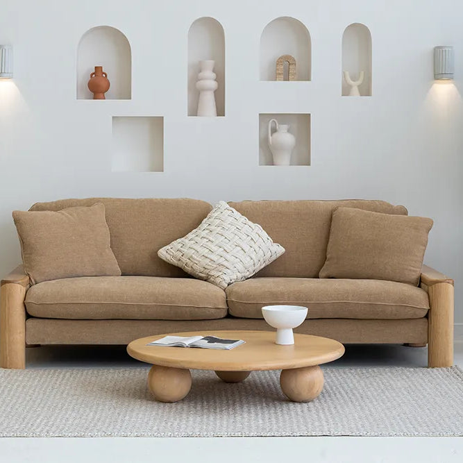 Beige sofa with a coffee table in a modern living room setting