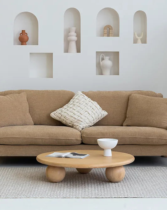 Beige sofa with a coffee table in a modern living room setting