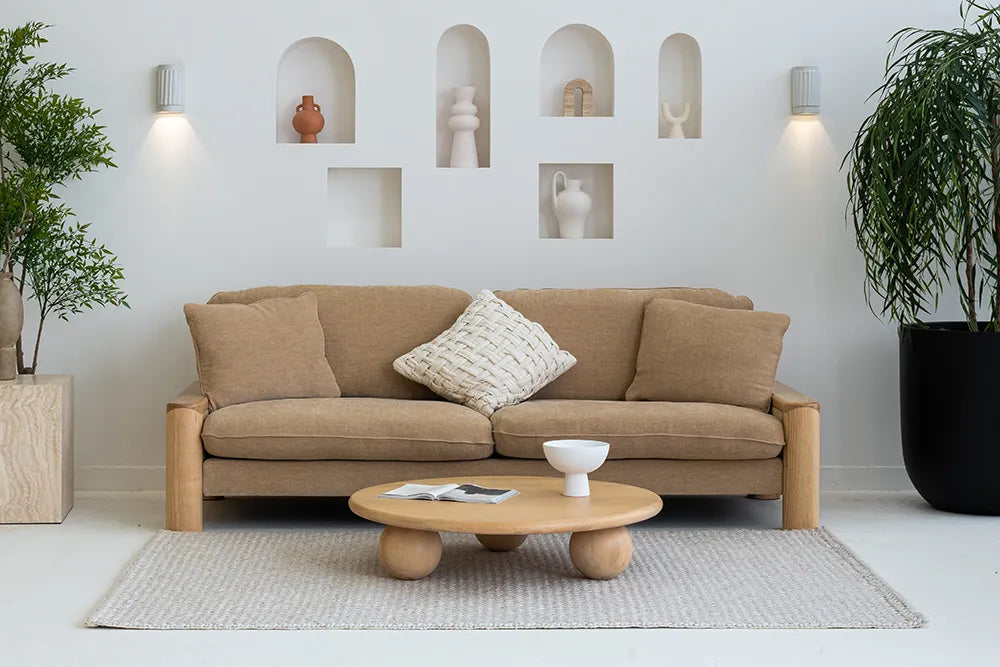 Beige sofa with a coffee table in a modern living room setting