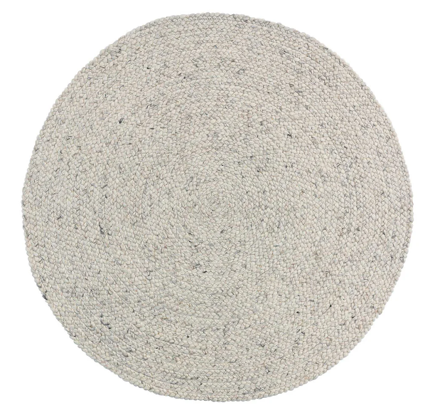 A round cream-colored wool blend rug with a traditional cable knit style.
