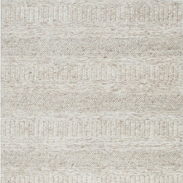A close-up image of a beige wool and nylon blend rug with a textured pattern.
