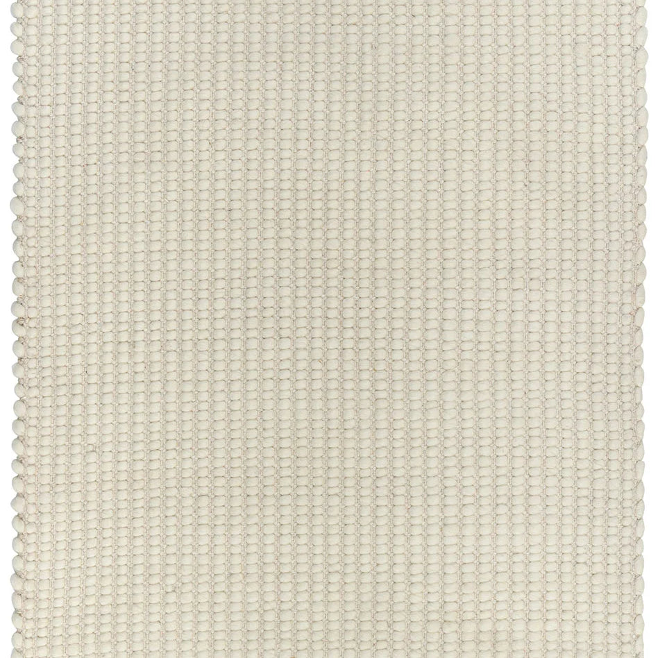 A white, handwoven rug with a textured looped design, made from a blend of wool, viscose, and cotton.