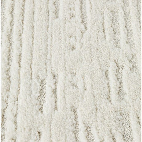 Textured beige rug on a concrete floor