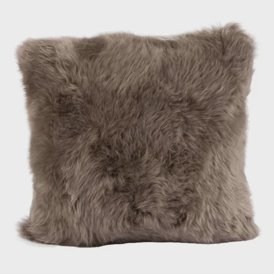 Fluffy brown sheepskin pillow on a white background