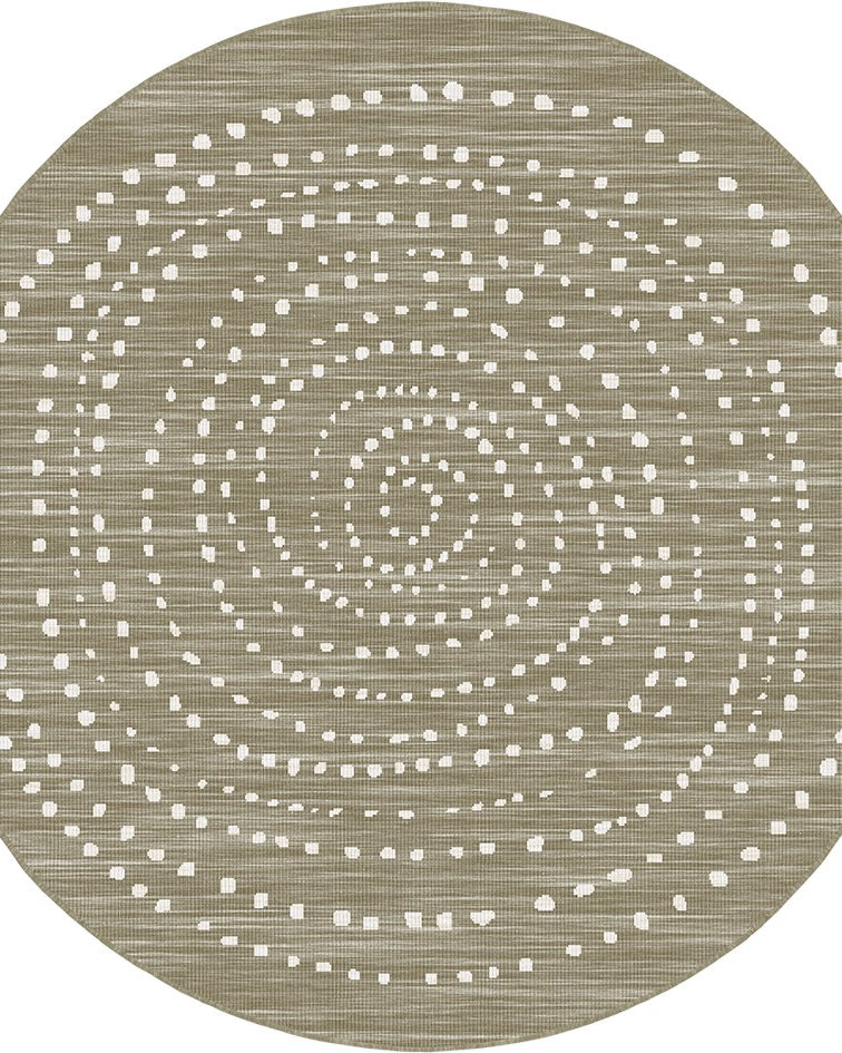 A round area rug with a textured, woven appearance in a warm taupe-beige color, decorated with concentric rings of small white dotted patterns.