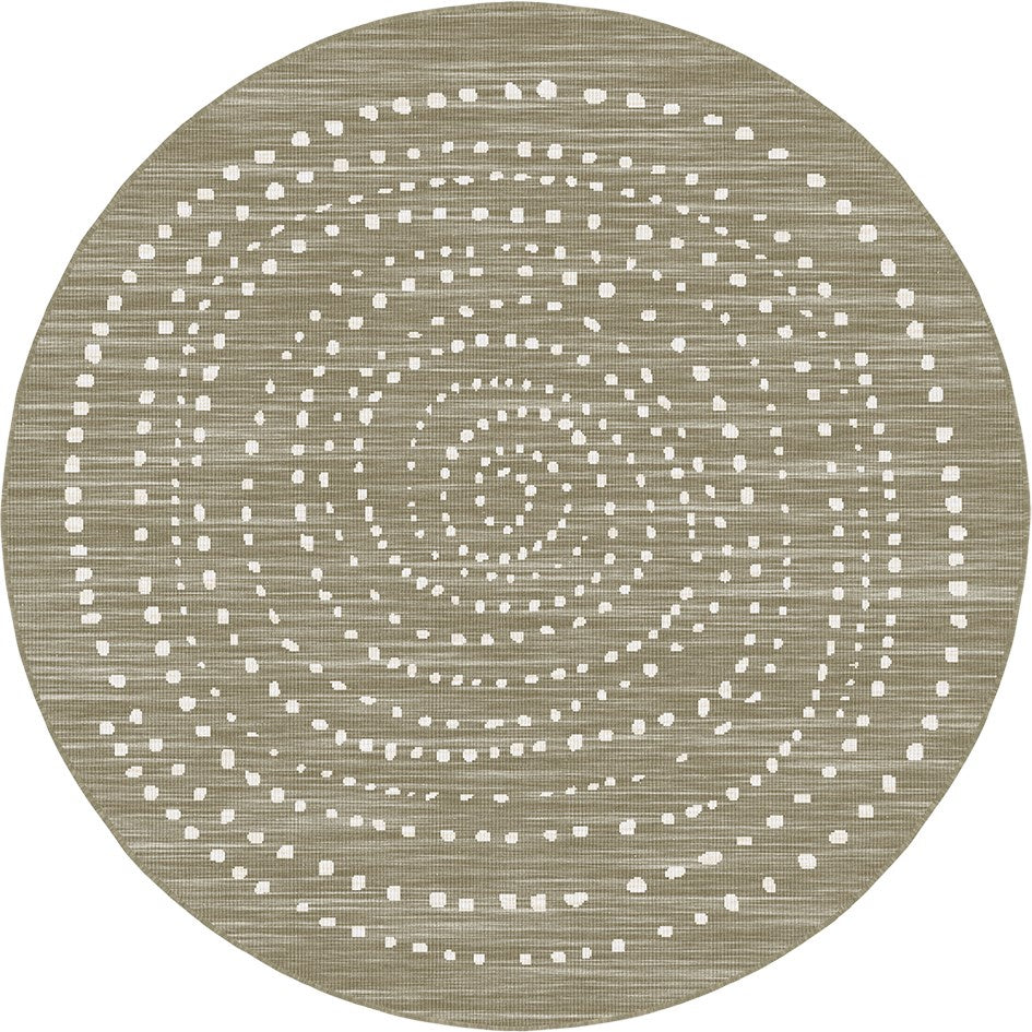 A round area rug with a textured, woven appearance in a warm taupe-beige color, decorated with concentric rings of small white dotted patterns.