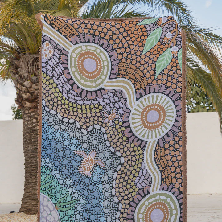 Colorful abstract design towel with palm tree in the background